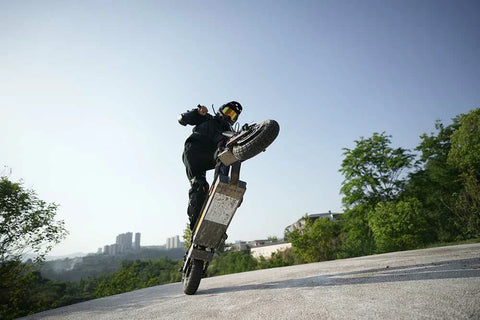 KuKirin G2 VMP electric scooter rider riding on a sunny urban bike lane